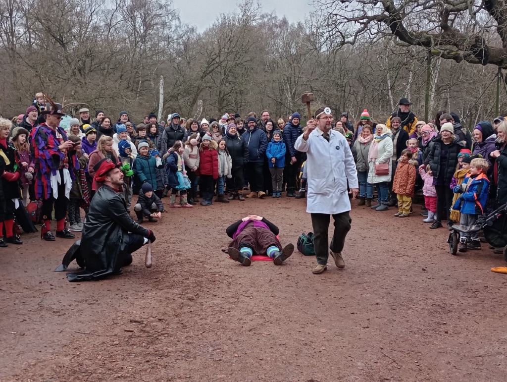 Actors being watched by an audience at Sherwood Forest.